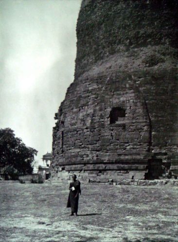 a monk at a stupa. stupa photo